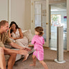 MeacoFan Sefte Smart 36" Tower Fan cooling a lounge while a family relaxes and a child runs past