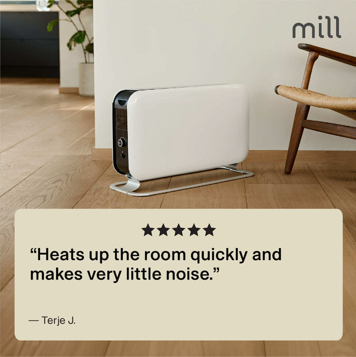 White air purifier on a wooden floor with a chair and plant in the background, featuring a product review quote.