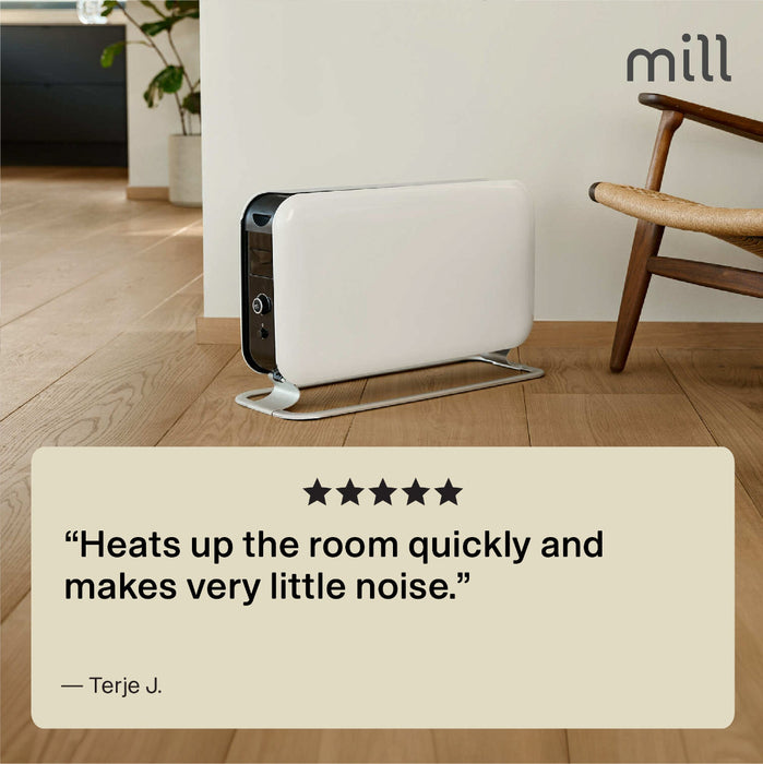 White air purifier on a wooden floor with a chair and plant in the background, featuring a product review quote.